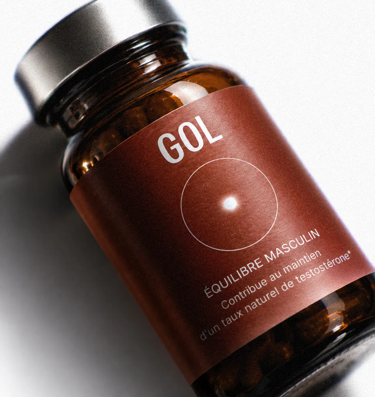 GOL Labs men’s supplement bottle featuring deep red packaging and circular brand motif